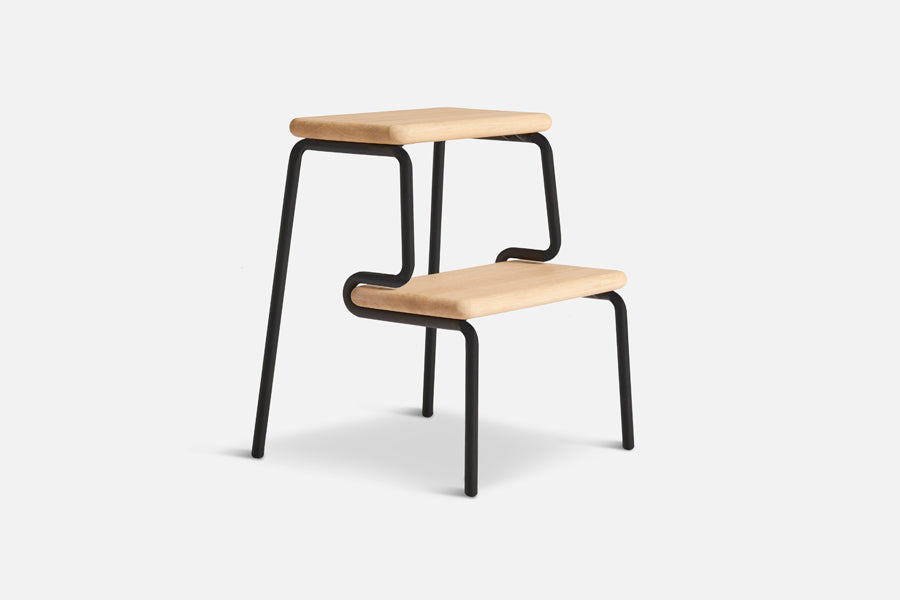 Slalom Step Stool by Woud, showing angle view of slalom step stool in live shot.