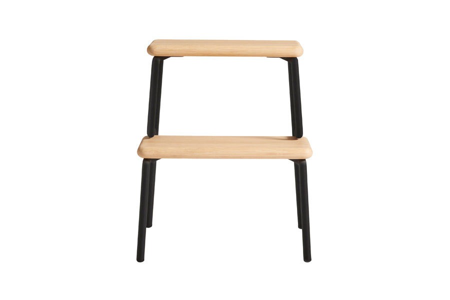 Slalom Step Stool by Woud, showing front view of slalom step stool in white pigmented lacquered oak with black painted legs.