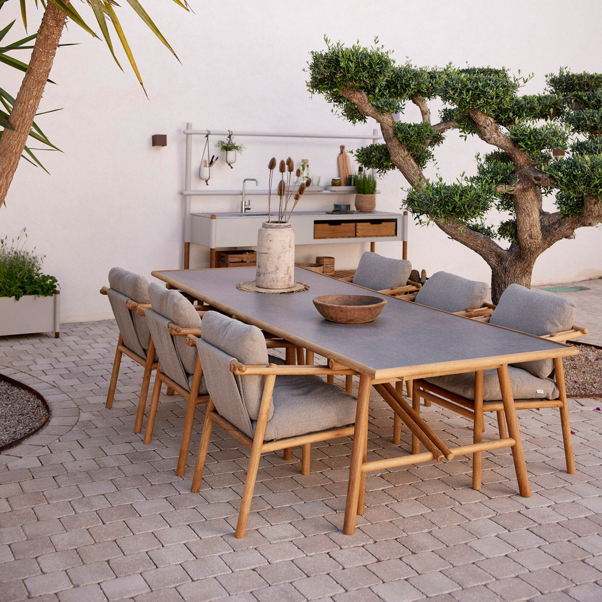 Sticks Armchair by Cane-Line, showing sticks armchairs in live shot.