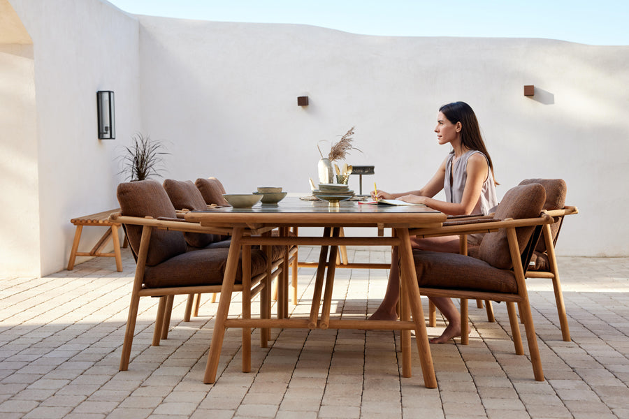 Sticks Armchair by Cane-Line, showing sticks armchairs in live shot.