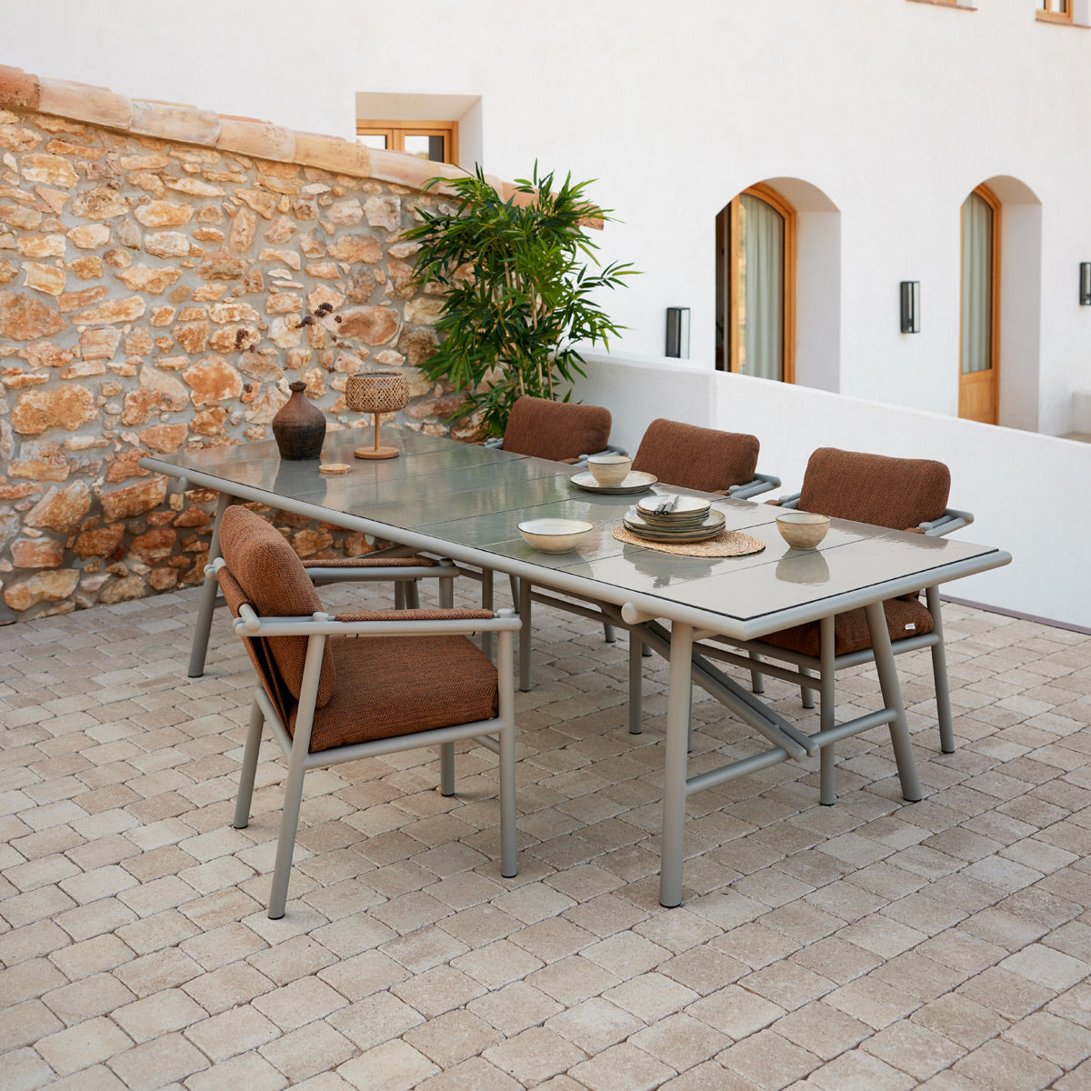 Sticks Dining Table by Cane-Line, showing sticks dining table in live shot.