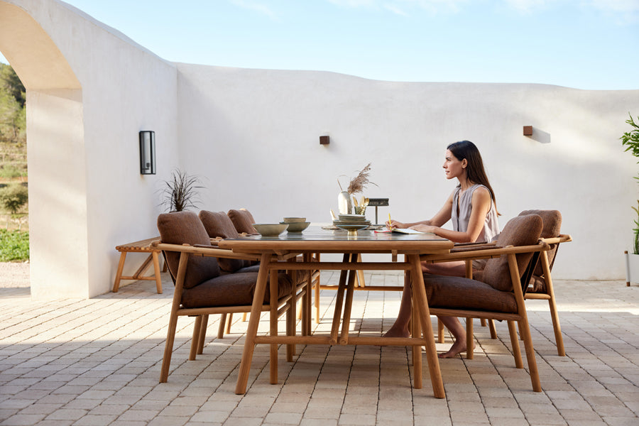 Sticks Dining Table by Cane-Line, showing sticks dining table in live shot.