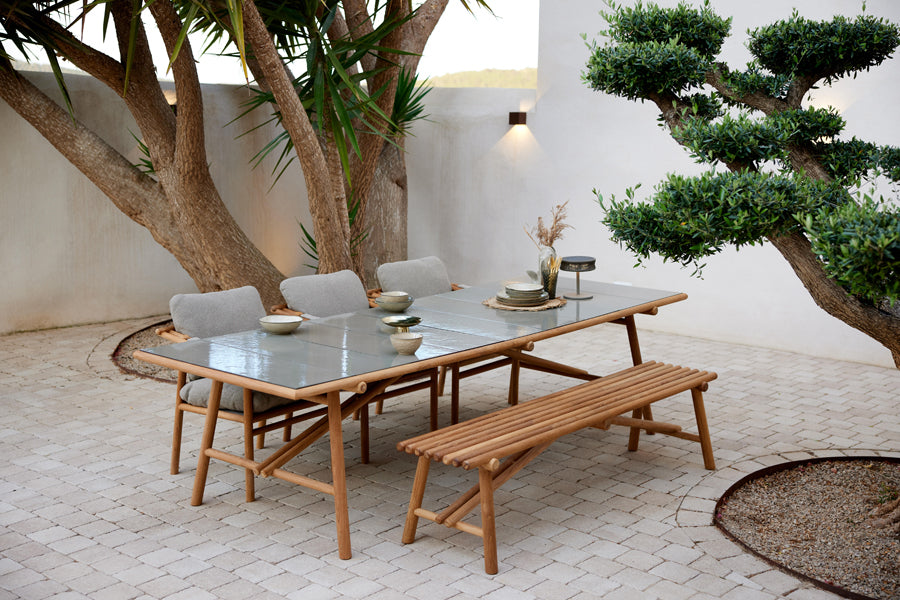 Sticks Dining Table by Cane-Line, showing sticks dining table in live shot.