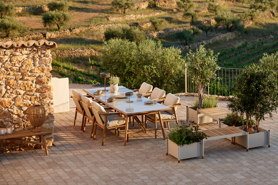 Sticks Dining Table by Cane-Line, showing sticks dining table in live shot.