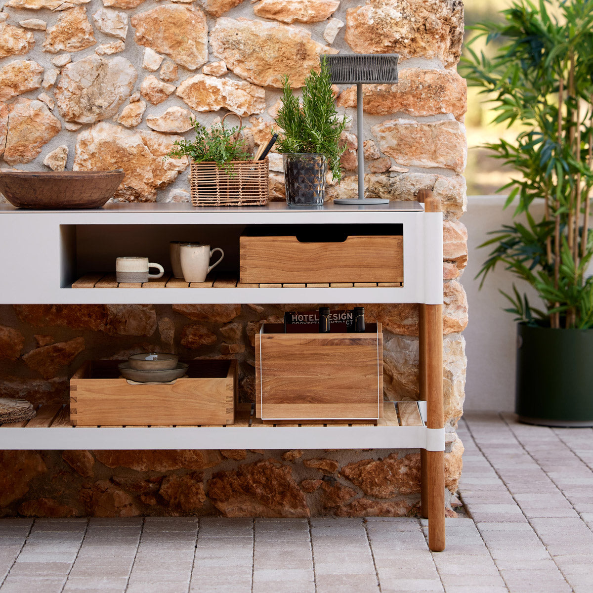 Sticks Kitchen Module with Teak Shelf by Cane-Line, showing closeup view of sticks kitchen module with teak shelf in live shot.
