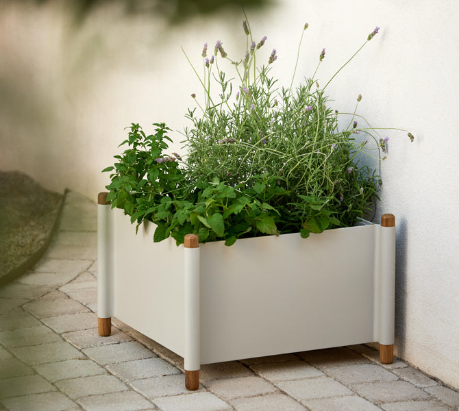 Sticks Planter by Cane-Line, showing sticks planter in live shot.