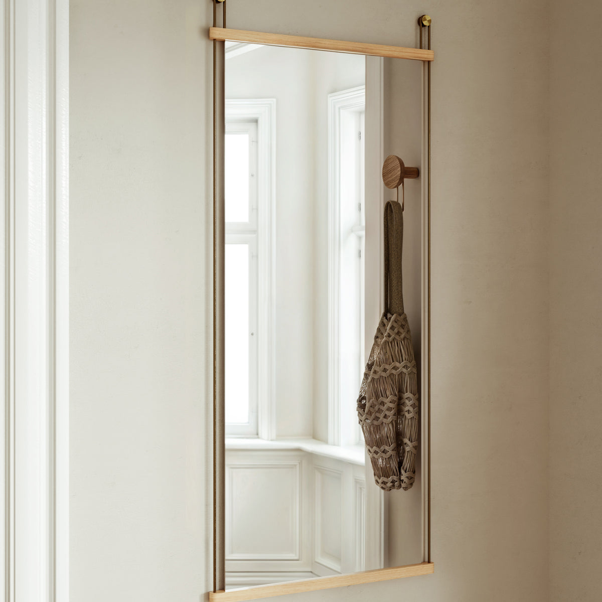 Suspended Mirror by Woud, showing suspended mirror in live shot.