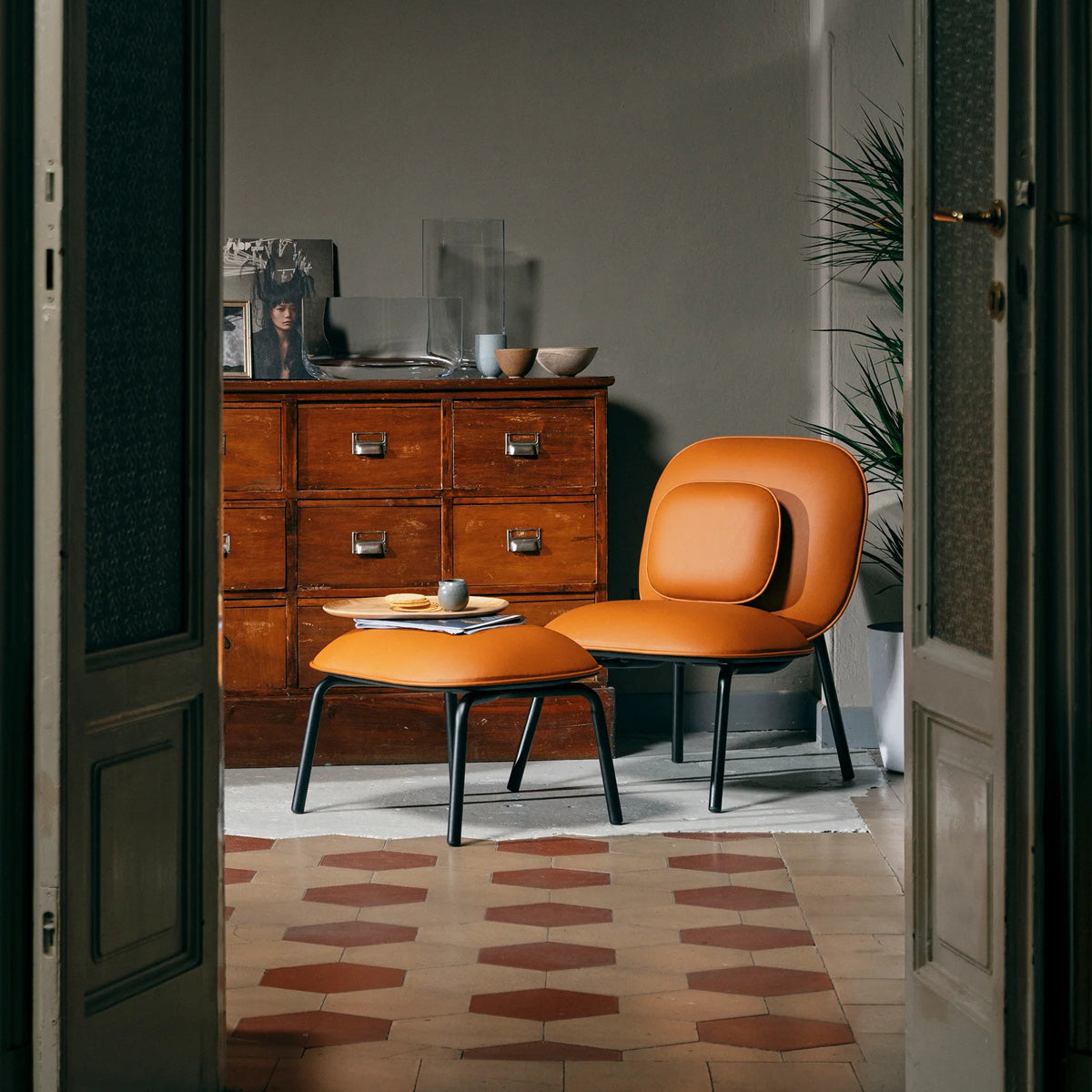Tasca Pillow by Toou, showing tasca pillow with lounge chair & ottoman in live shot.