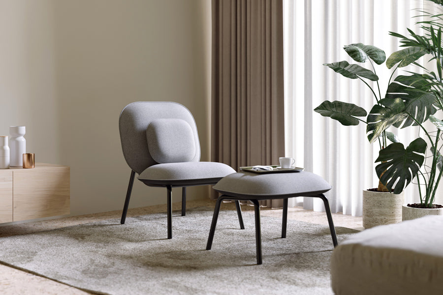 Tasca Pillow by Toou, showing tasca pillow with lounge chair & ottoman in live shot.