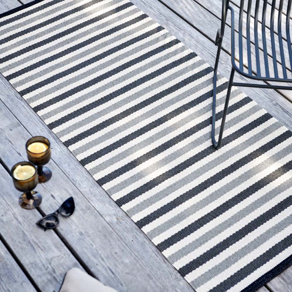 Teo Warm Grey & Charcoal with Vanilla Rug by Pappelina, showing teo warm grey & charcoal with vanilla rug in live shot.