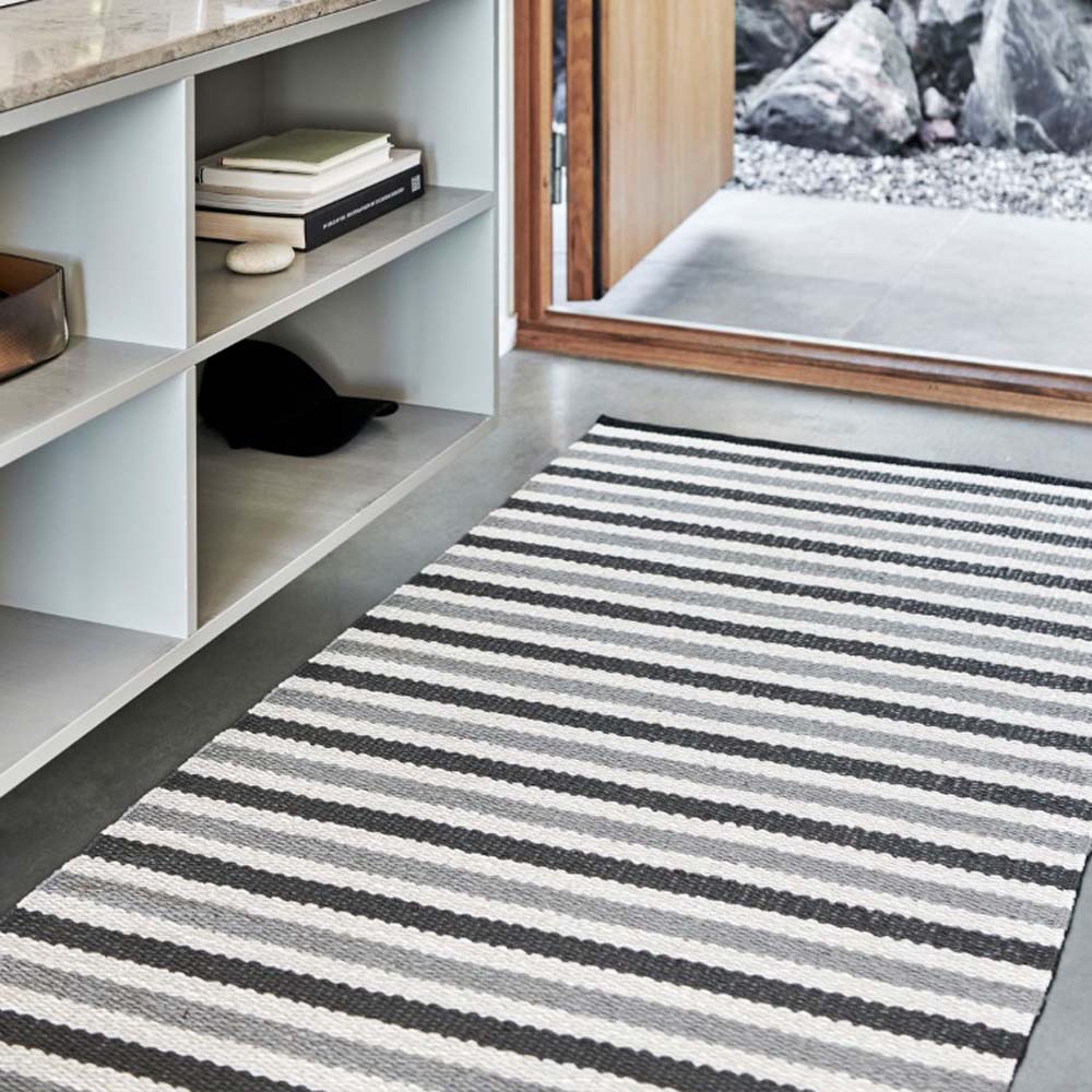 Teo Warm Grey & Charcoal with Vanilla Rug by Pappelina, showing teo warm grey & charcoal with vanilla rug in live shot.