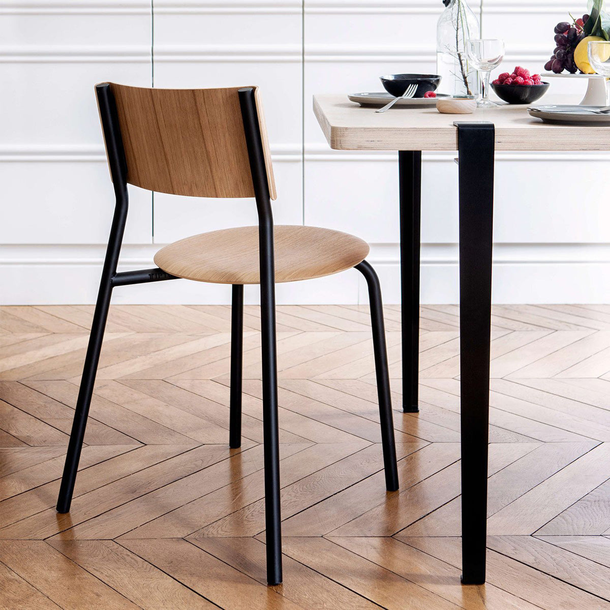 Tiptoe Dining Table by TipToe, showing closeup view of tiptoe dining table in live shot.