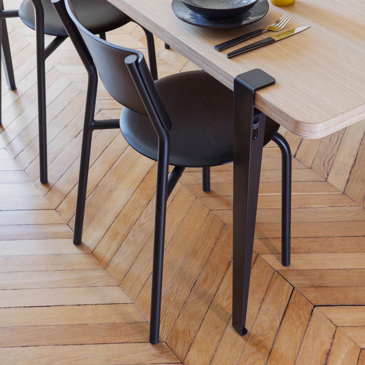 Tiptoe Dining Table by TipToe, showing closeup view of tiptoe dining table in live shot.