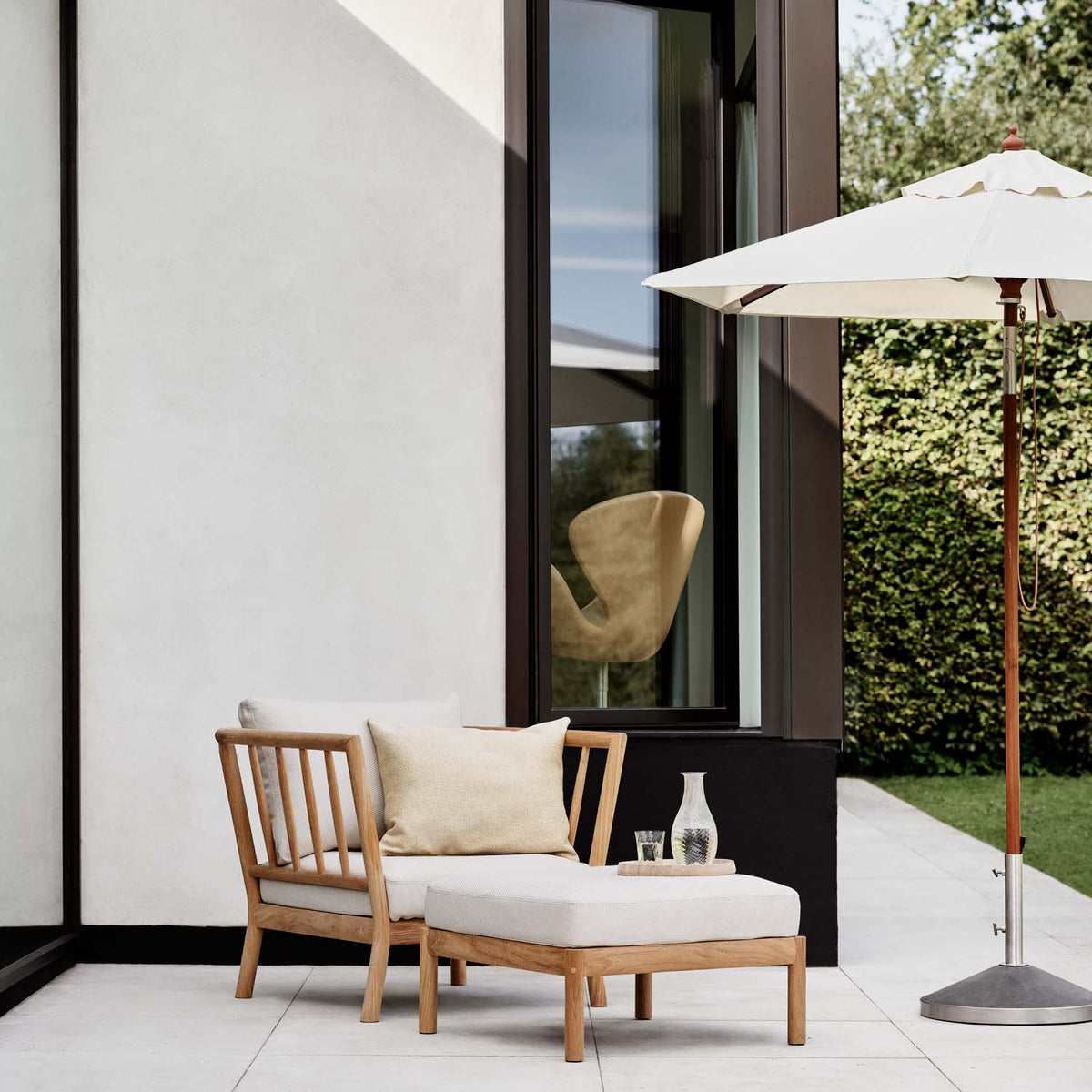 Tradition Pouf by Skagerak, showing tradition pouf in live shot.