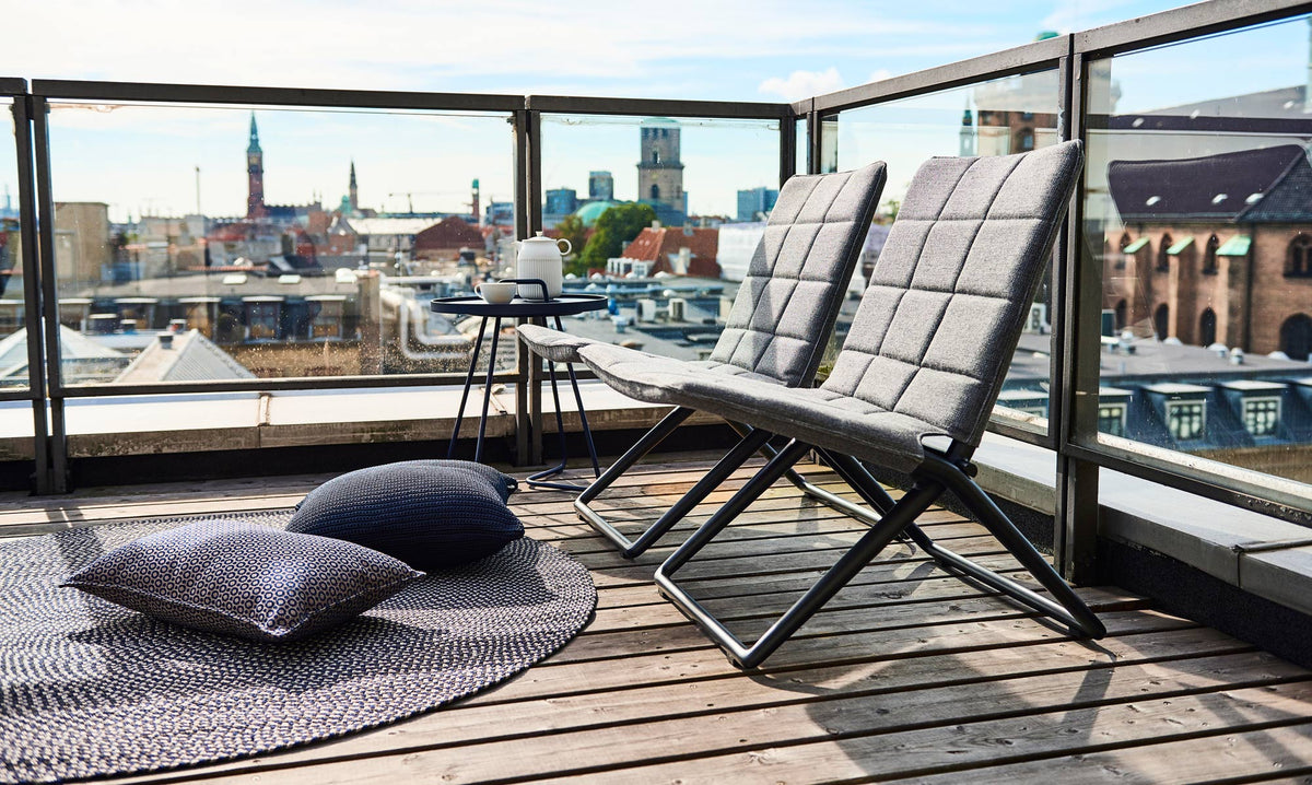 Traveller Lounge Folding Chair by Cane-Line, showing traveller lounge folding chairs in live shot.