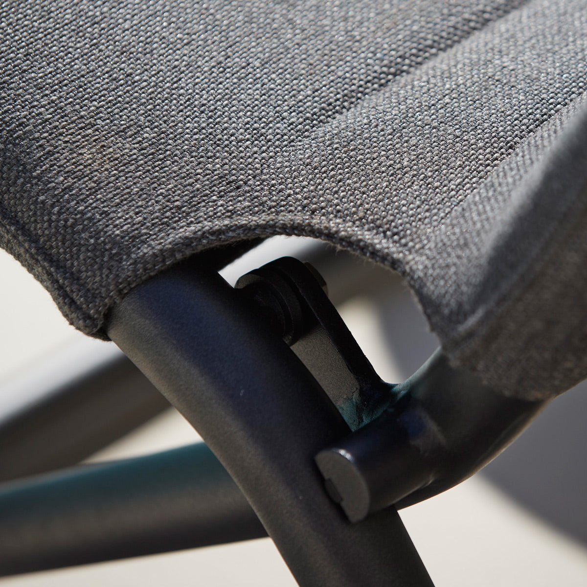 Traveller Lounge Folding Chair by Cane-Line, showing closeup view of traveller lounge folding chair in live shot.
