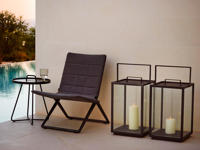 Traveller Lounge Folding Chair by Cane-Line, showing traveller lounge folding chair in live shot.