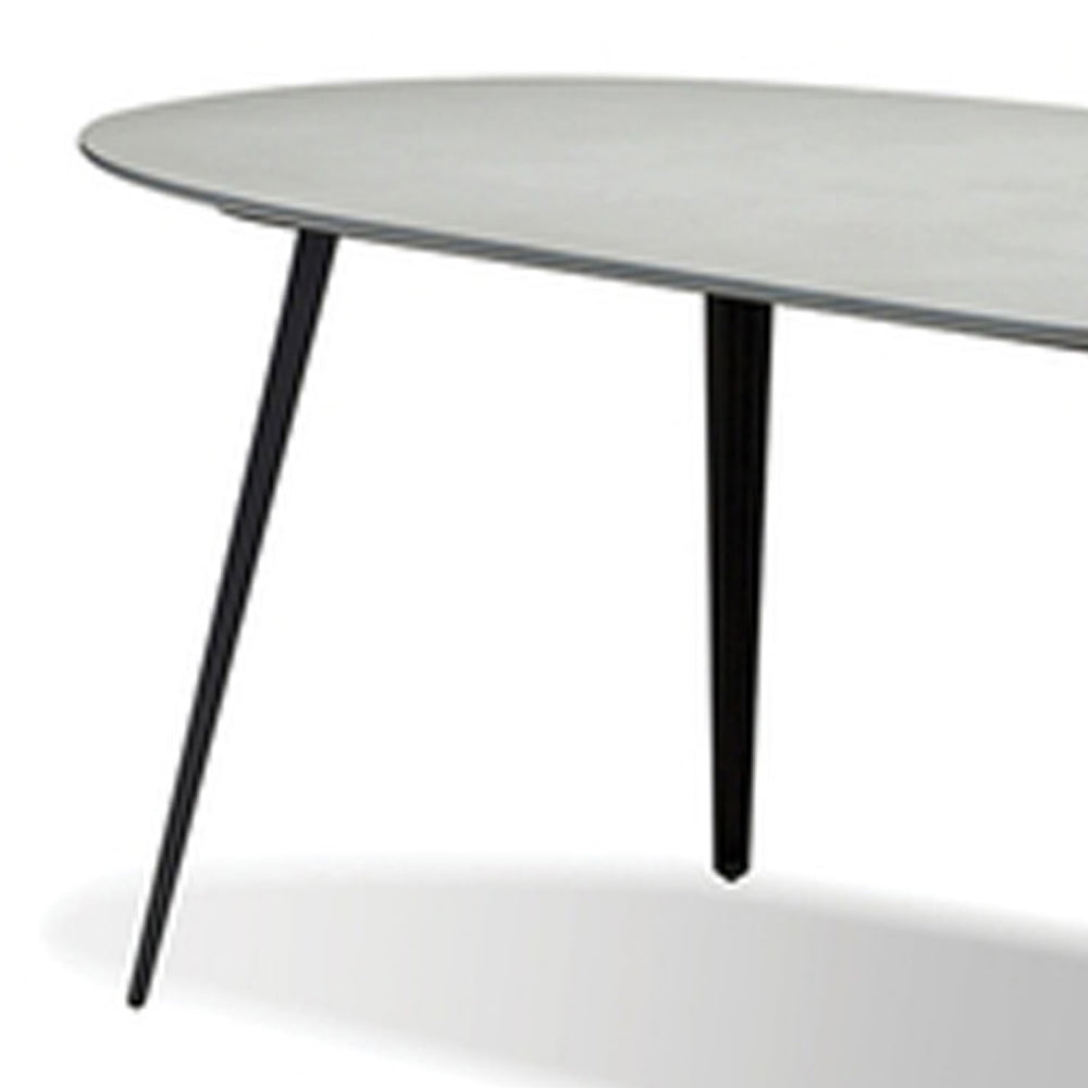 Tulum Dining Table by Mobital, showing closeup view of tulum dining table in matte Grey epoxy concrete texture/black galv steel legs.