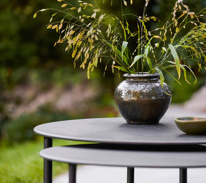 Twist Large Coffee Table by Cane-Line, showint twist large coffee table in live shot.