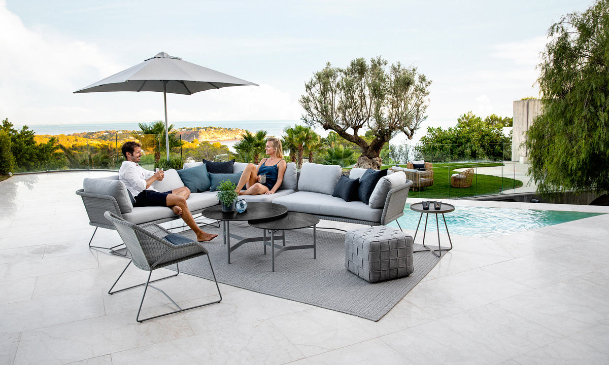 Twist Large Coffee Table by Cane-Line, showint twist large coffee table in live shot.