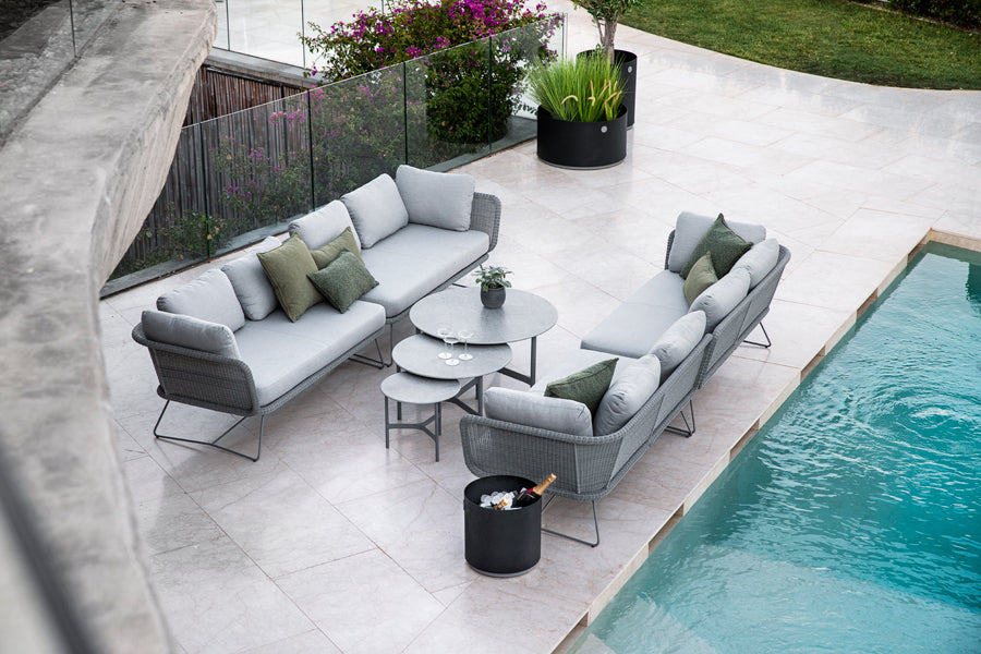 Twist Large Coffee Table by Cane-Line, showint twist large coffee table in live shot.