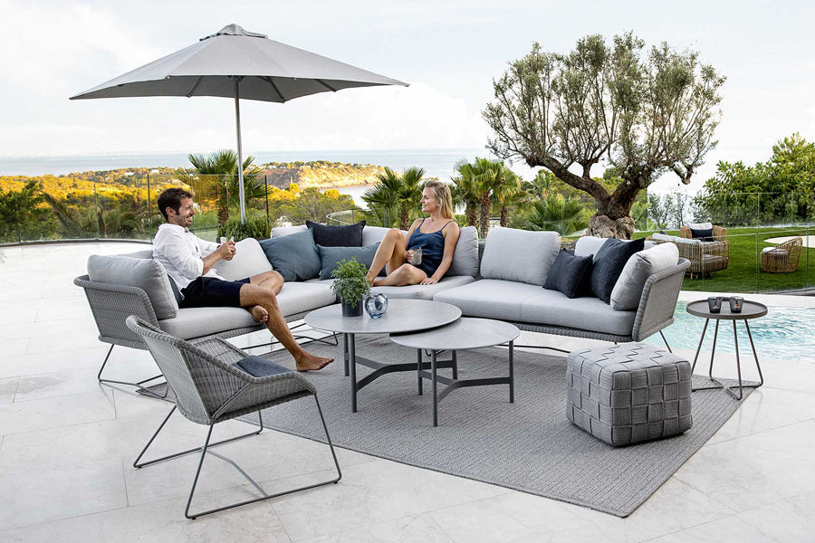 Twist Medium Coffee Table by Cane-Line, showing twist medium coffee table in live shot.