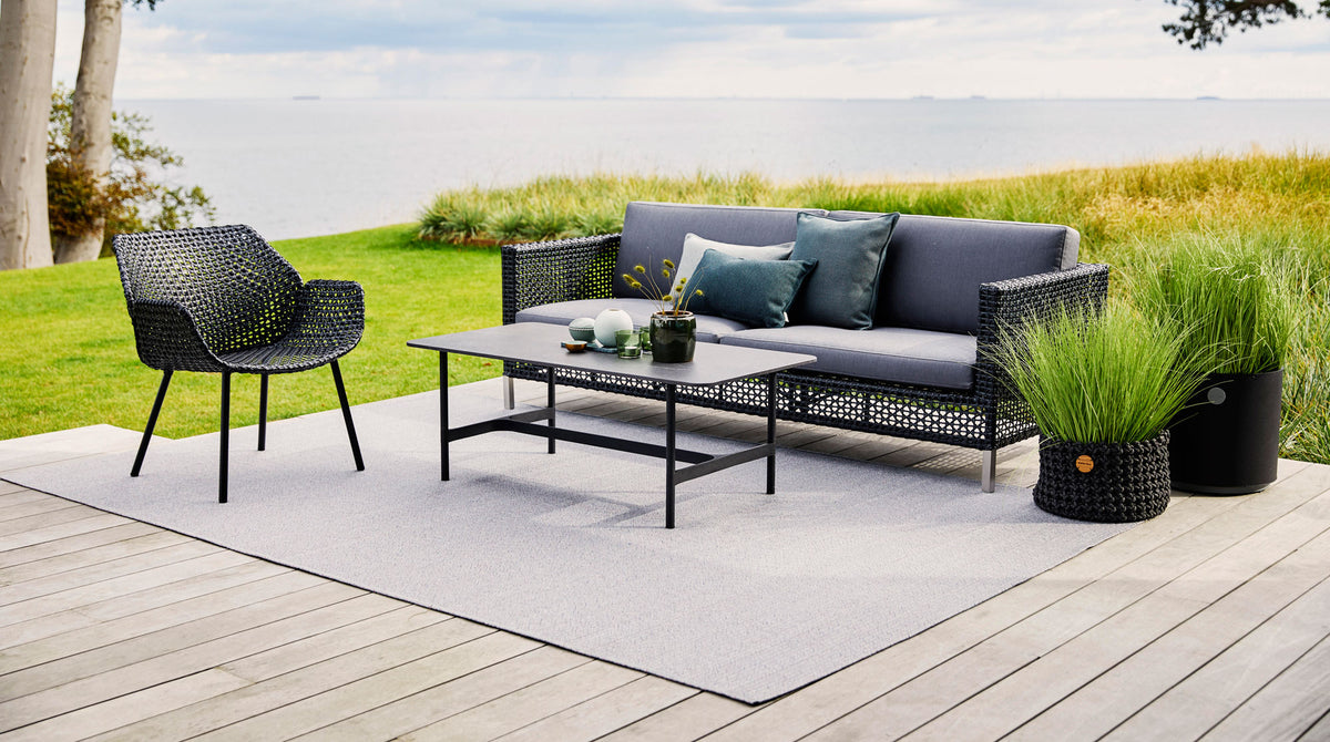 Twist Rectangular Coffee Table by Cane-Line, showing twist rectangular coffee table in live shot.