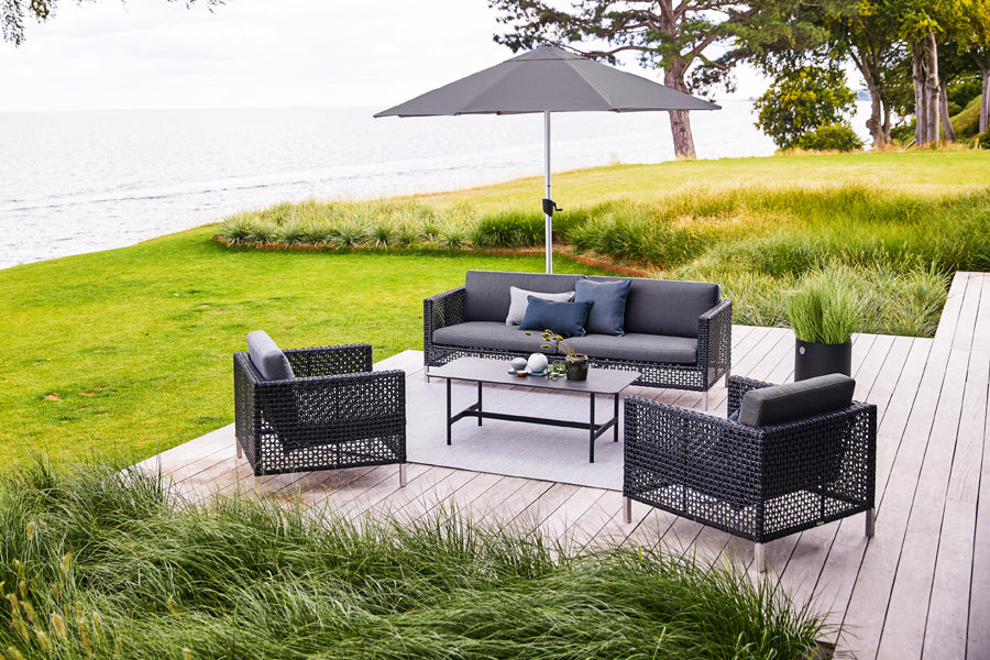 Twist Rectangular Coffee Table by Cane-Line, showing twist rectangular coffee table in live shot.