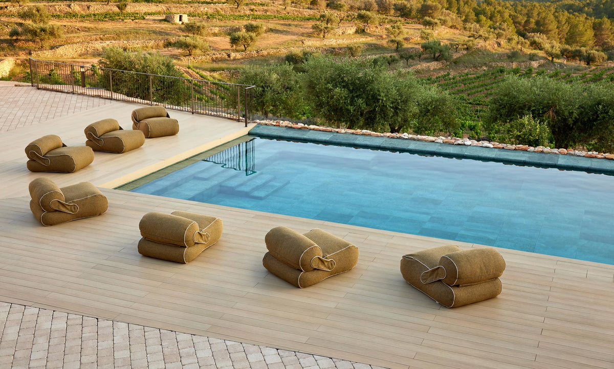 Unite Lounge Chair by Cane-Line, showing unite lounge chairs in live shot.