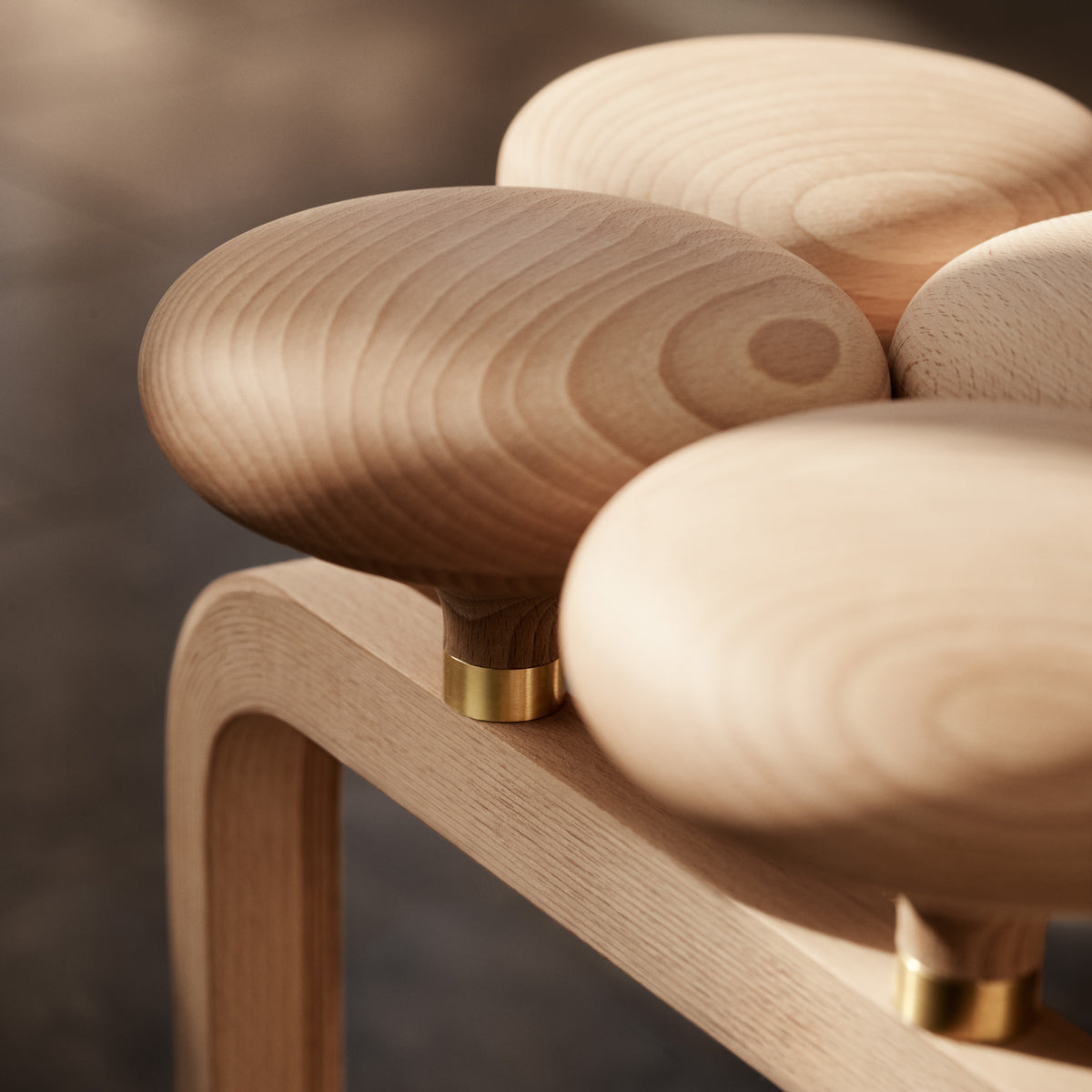 Utzon Stool by Fritz Hansen, showing closeup view of utzon stool in live shot.