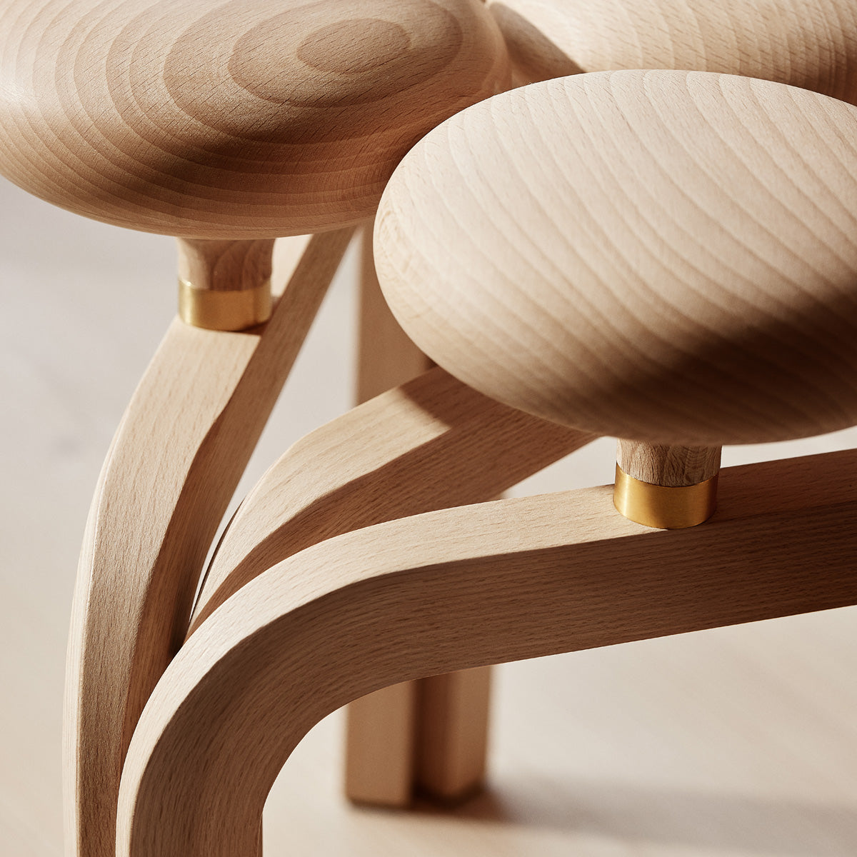 Utzon Stool by Fritz Hansen, showing closeup view of utzon stool in live shot.