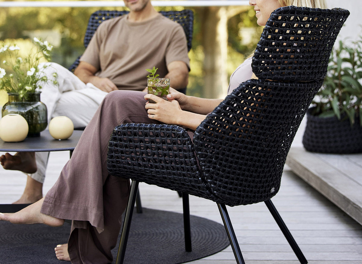 Vibe Highback Chair by Cane-Line, showing vibe highback chair in live shot.