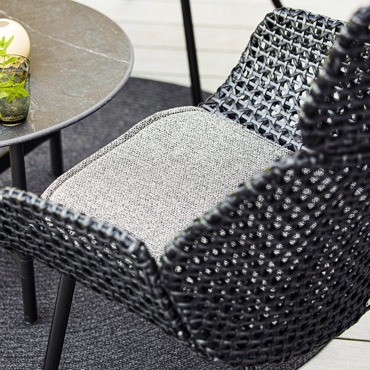 Vibe Highback Chair by Cane-Line, showing closeup view of vibe highback chair in live shot.