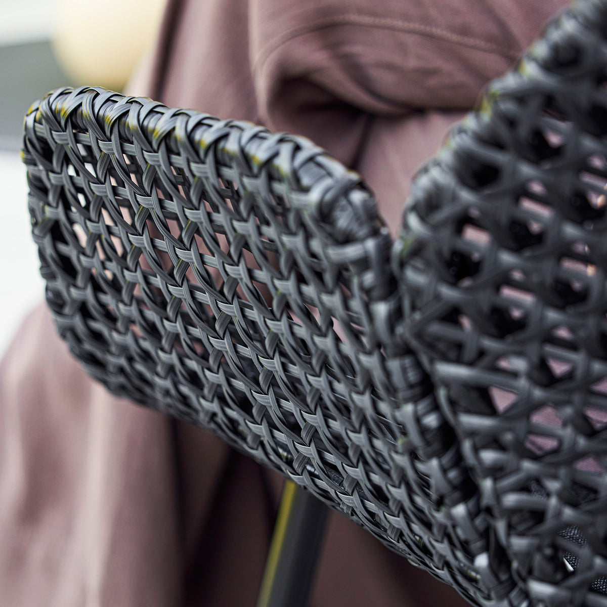 Vibe Highback Chair by Cane-Line, showing closeup view of vibe highback chair in live shot.
