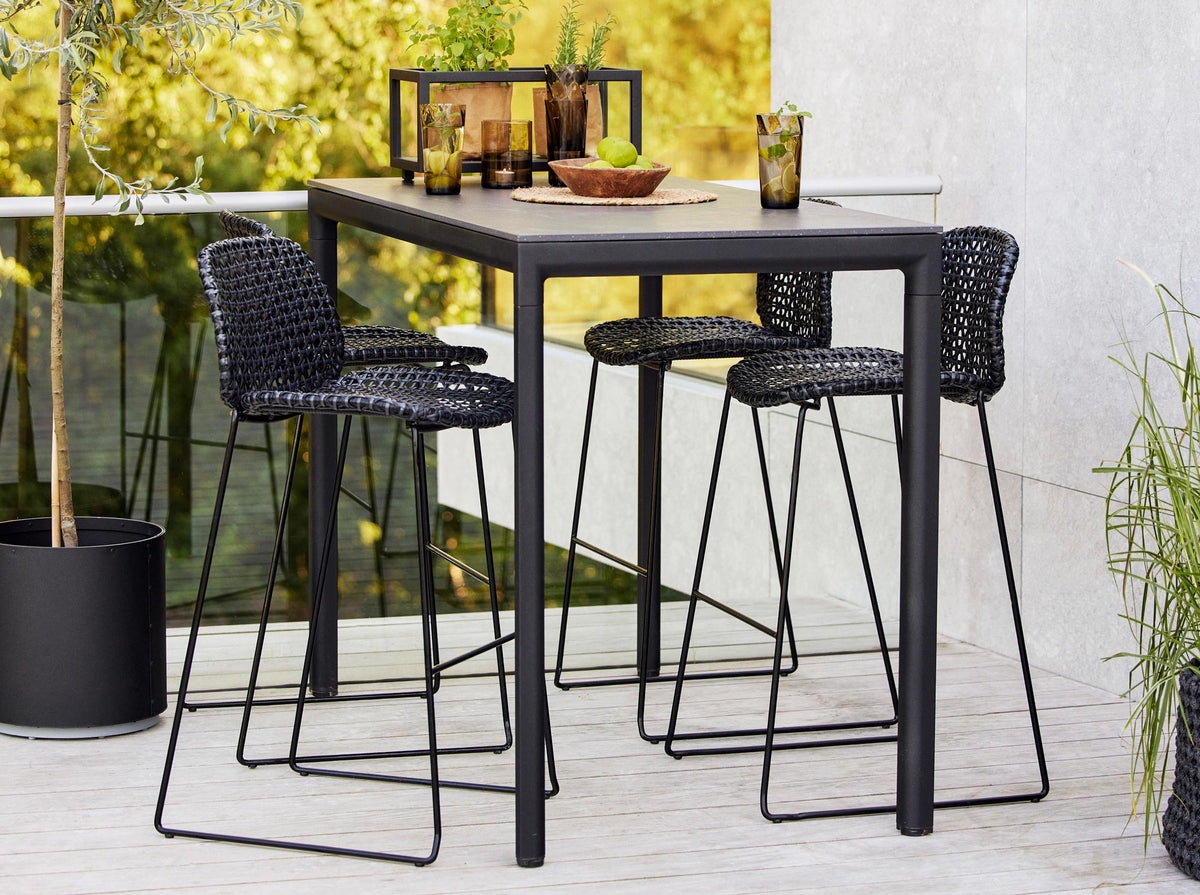 Vibe Stackable Bar Chair by Cane-Line, showing vibe stackable bar chairs in live shot.