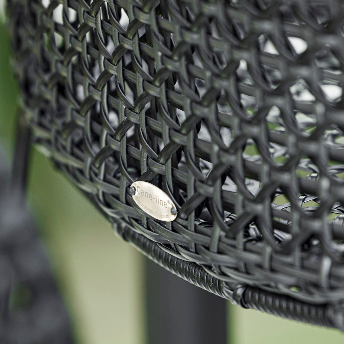 Vibe Stackable Bar Chair by Cane-Line, showing closeup view of vibe stackable bar chair in live shot.