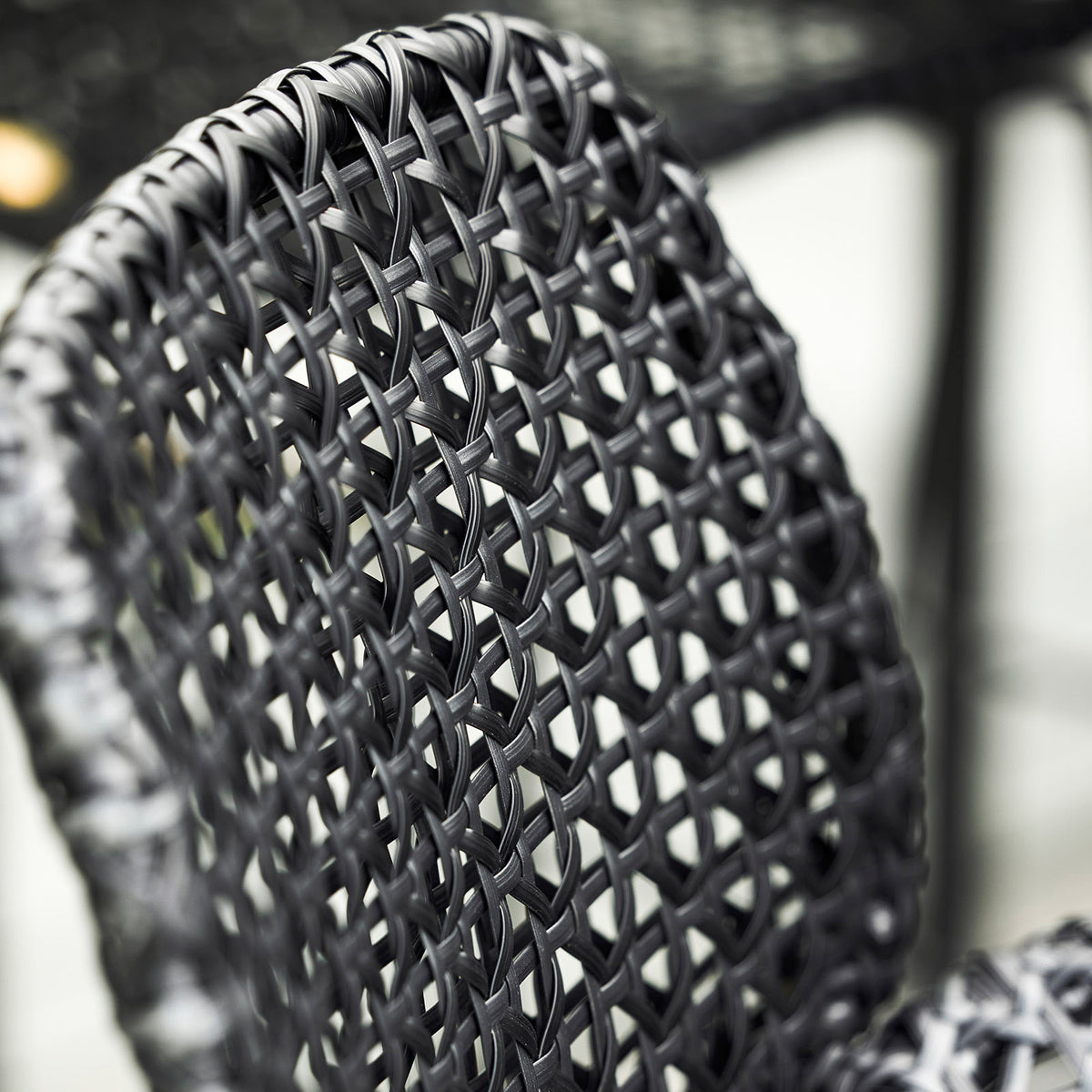 Vibe Stackable Bar Chair by Cane-Line, showing closeup view of vibe stackable bar chair in live shot.