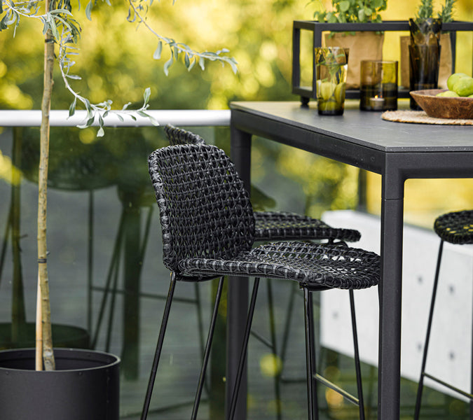 Vibe Stackable Bar Chair by Cane-Line, showing closeup view of vibe stackable bar chairs in live shot.