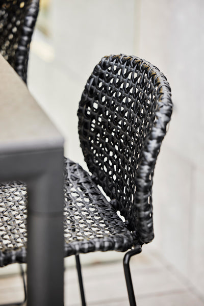 Vibe Stackable Bar Chair by Cane-Line, showing closeup view of vibe stackable bar chair in live shot.