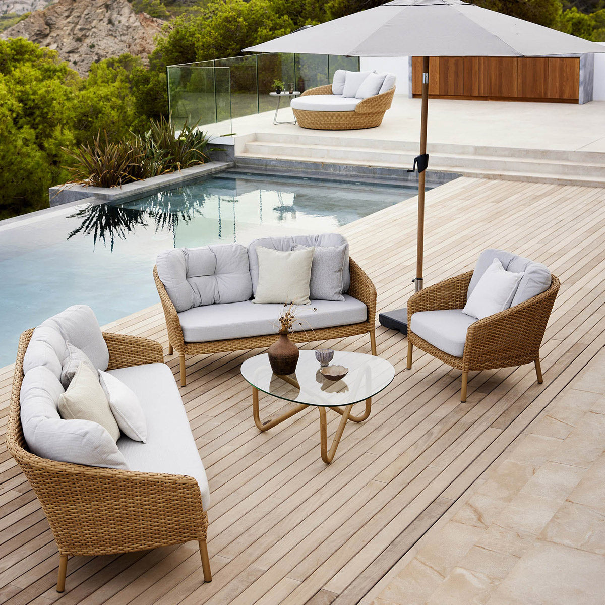 Wave Outdoor Coffee Table by Cane-Line, showing wave outdoor coffee table in live shot.