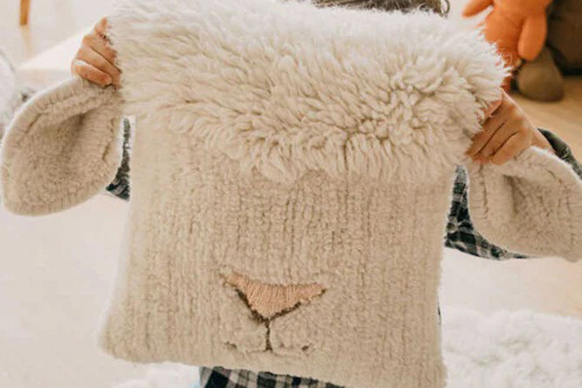 Pink Nose Sheep Woolable Cushion by Lorena Canals, showing pink nose sheep woolable cushion in live shot.
