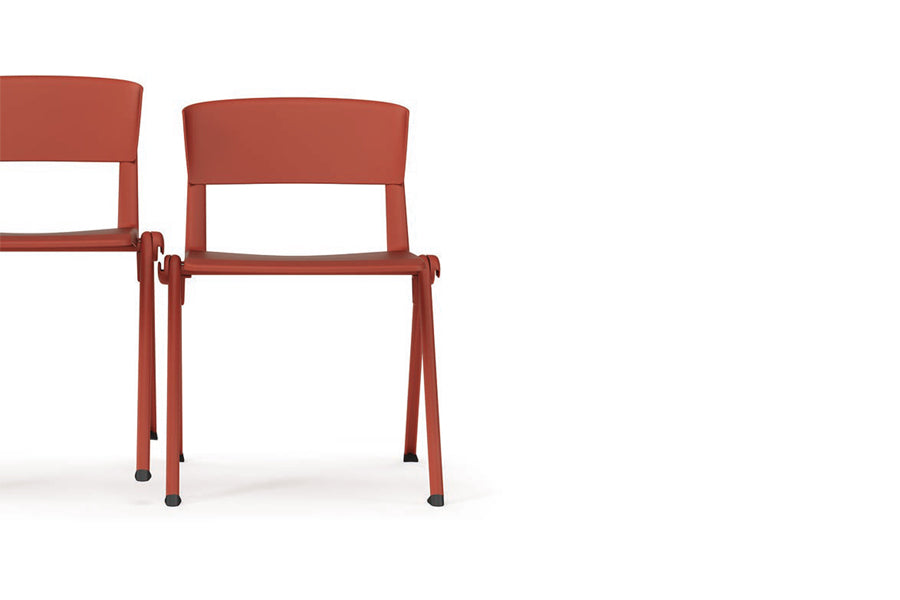 Yugen Stacking Armless Chair by Kollektiff, showing front/closeup view of yugen stacking armless chairs in corel red metal/corel red plastic.