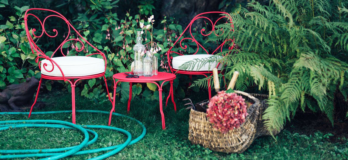 1900 Low Table by Fermob, showing front view of low table with chair in the live shot.