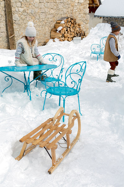 1900 Stacking Armchair by Fermob, showing live shoot of the chair with table.