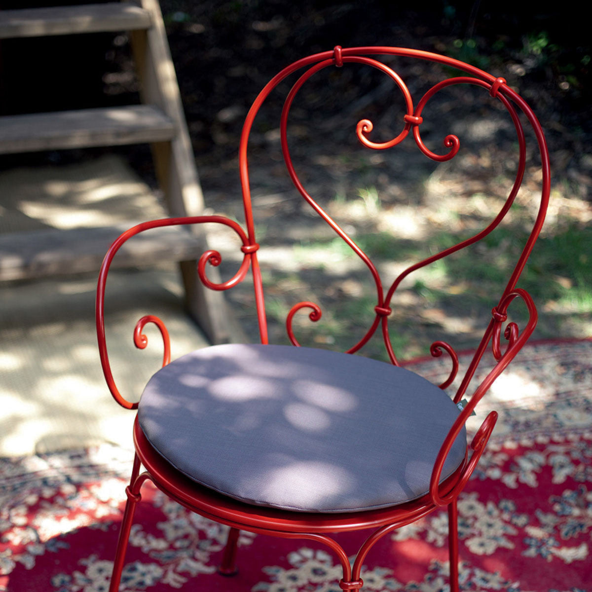 1900 Stacking Armchair by Fermob, showing closeup view of stacking armchair in live shot.