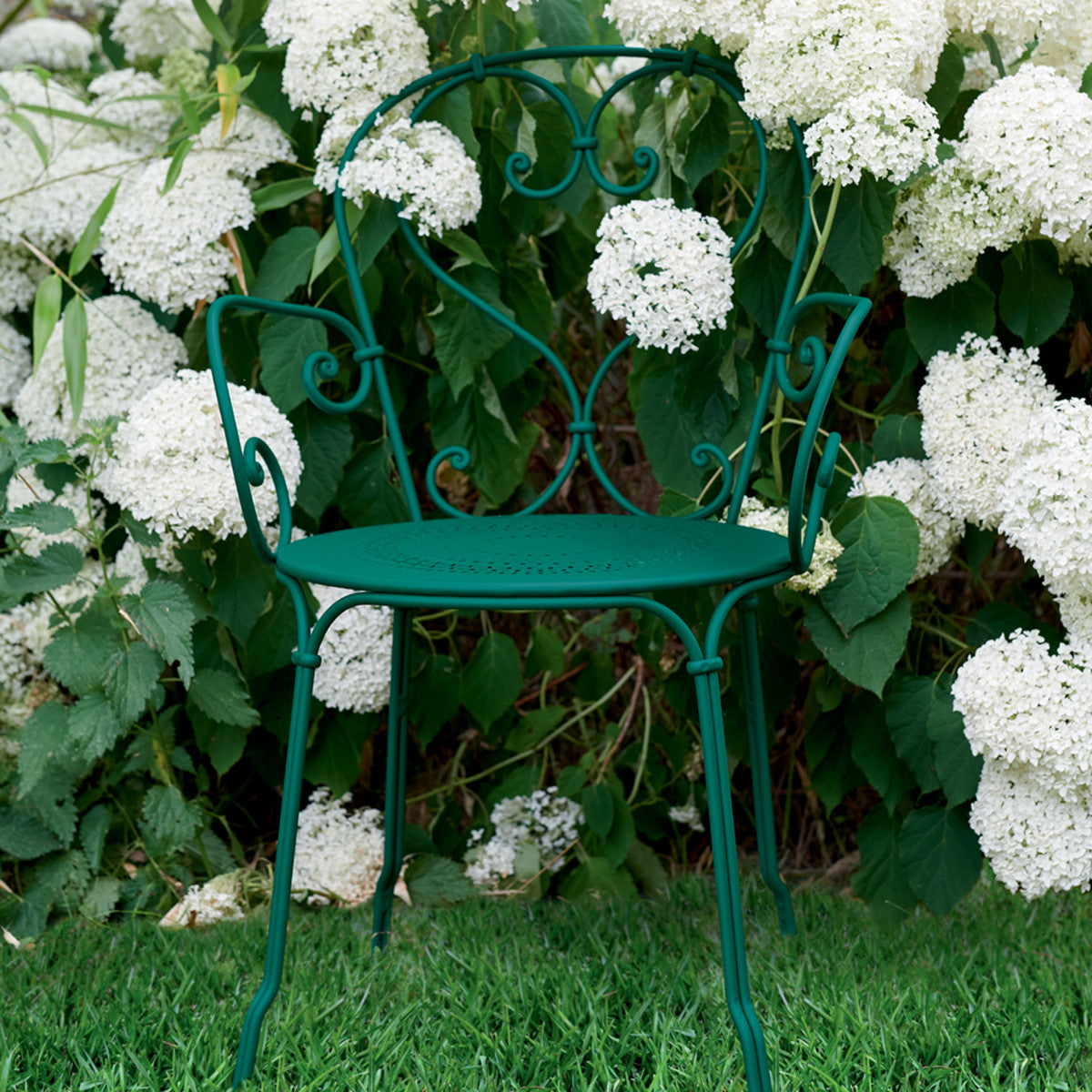 1900 Stacking Armchair by Fermob, showing front view of stacking armchair in live shot.