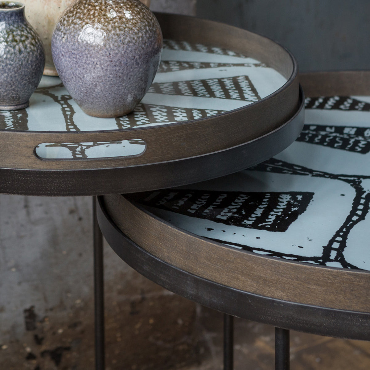 Tray Side Table by Ethnicraft, showing closeup view of tray side table sets in live shot.
