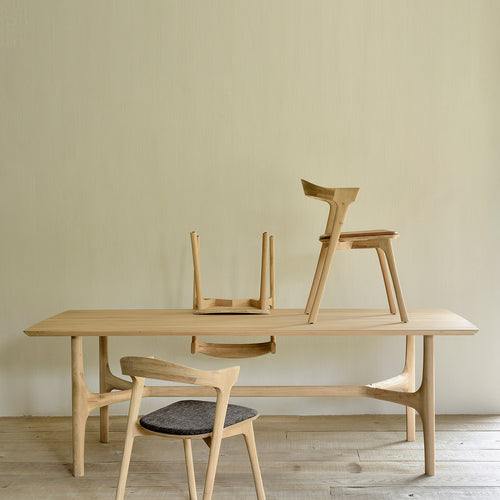 Nexus Dining Table by Ethnicraft, showing front view of dining table with chairs in the live shot.