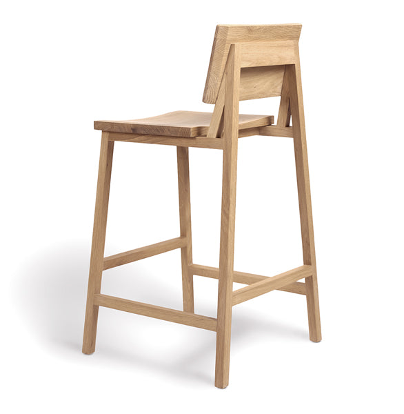 N3 Counter Stool by Ethnicraft, showing angle back view of n3 kitchen counter stool in oak.