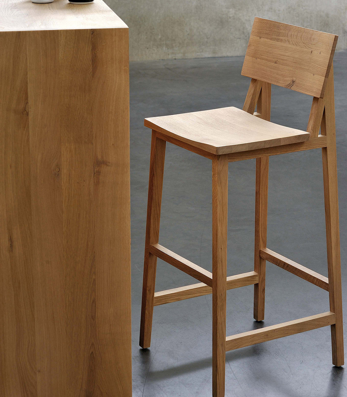 N4 Bar Stool by Ethnicraft, showing angle view of n4 bar chair in live shot.